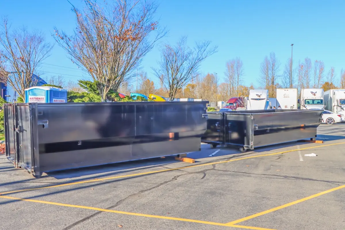 Professional dumpster rental service with roll-off container on residential driveway in Estelle